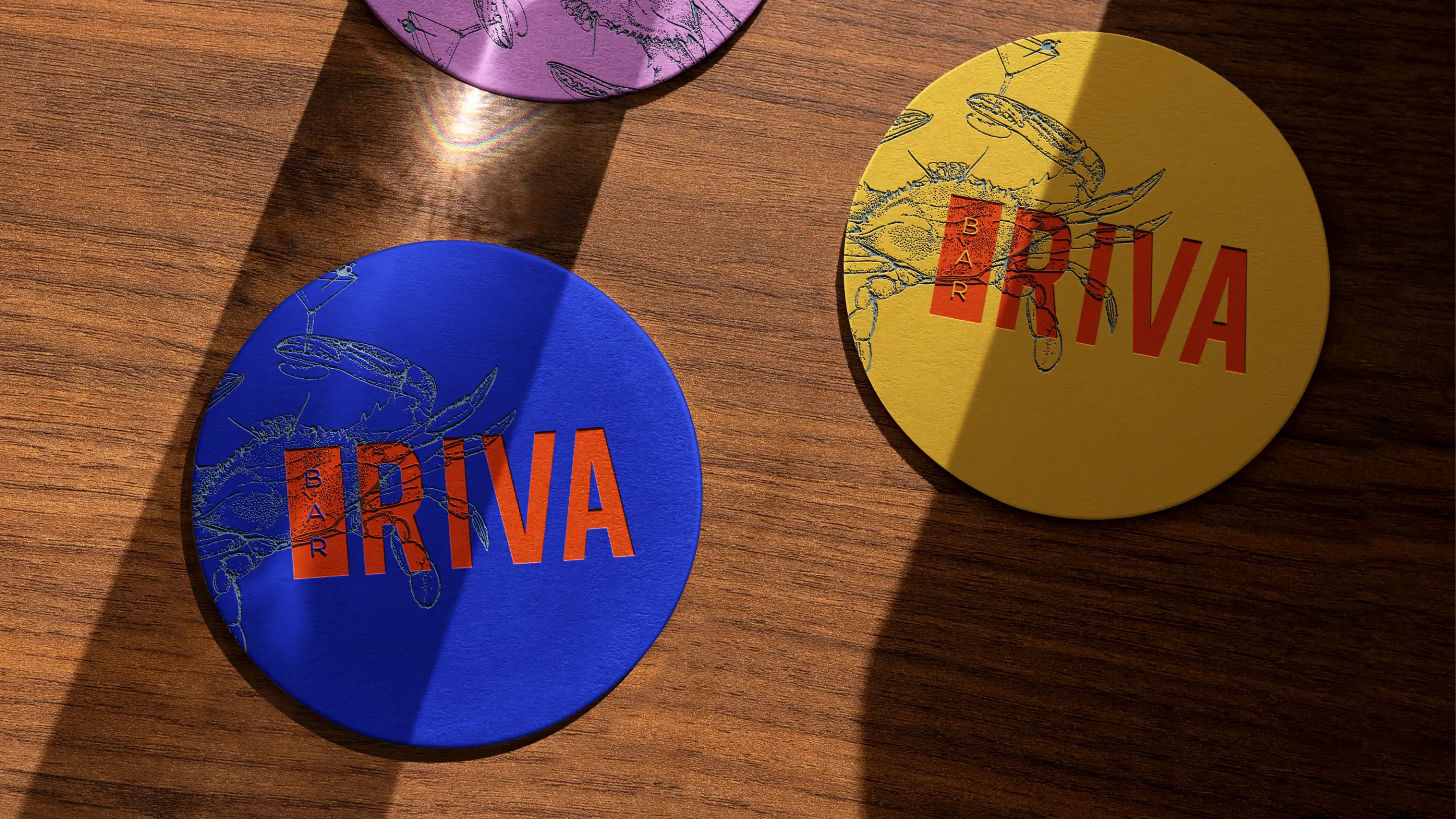Bar Riva crab logo on thick paper coasters on bar.