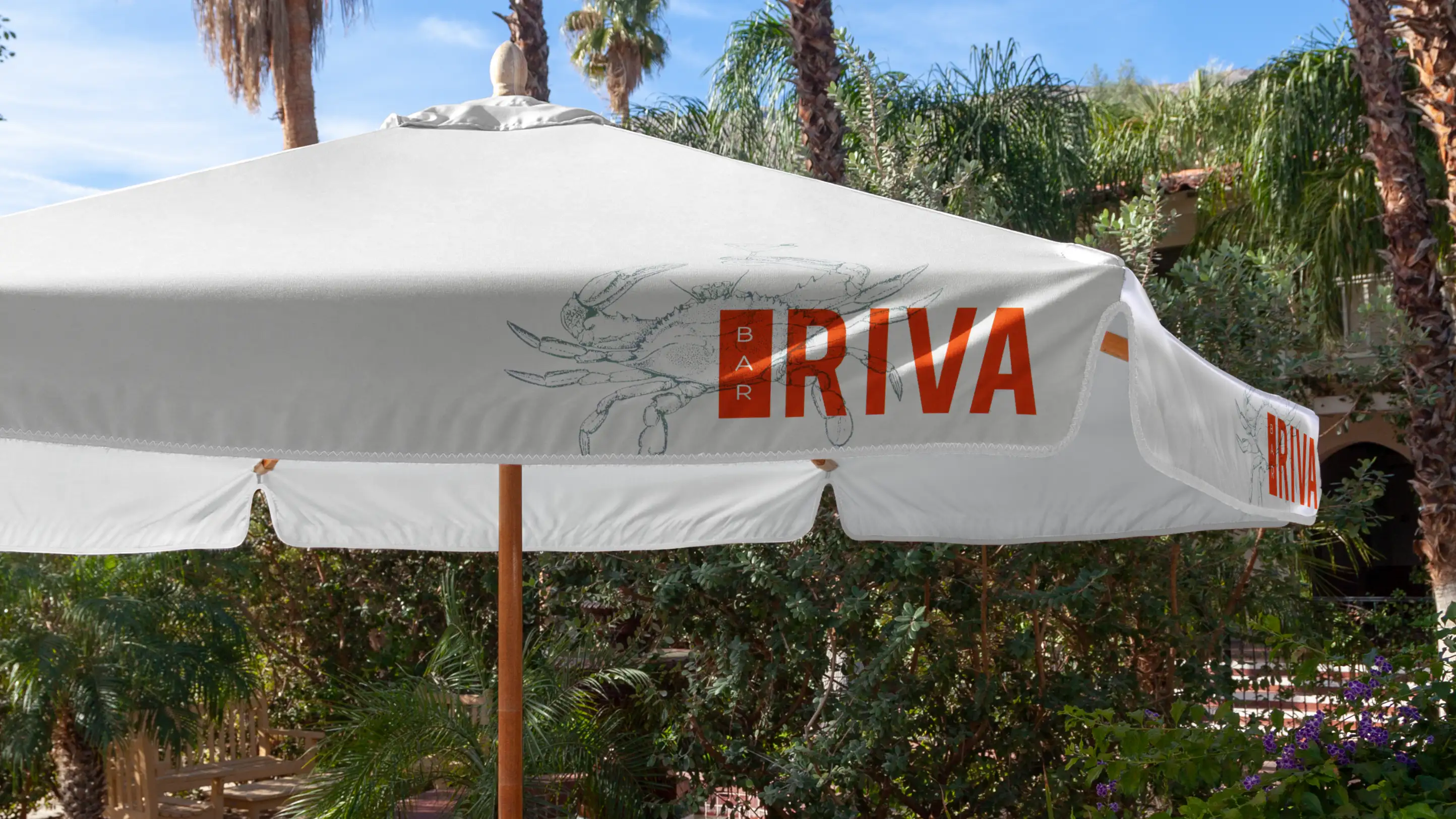 Red and blue Bar Riva logo on white pool cabana umbrella.