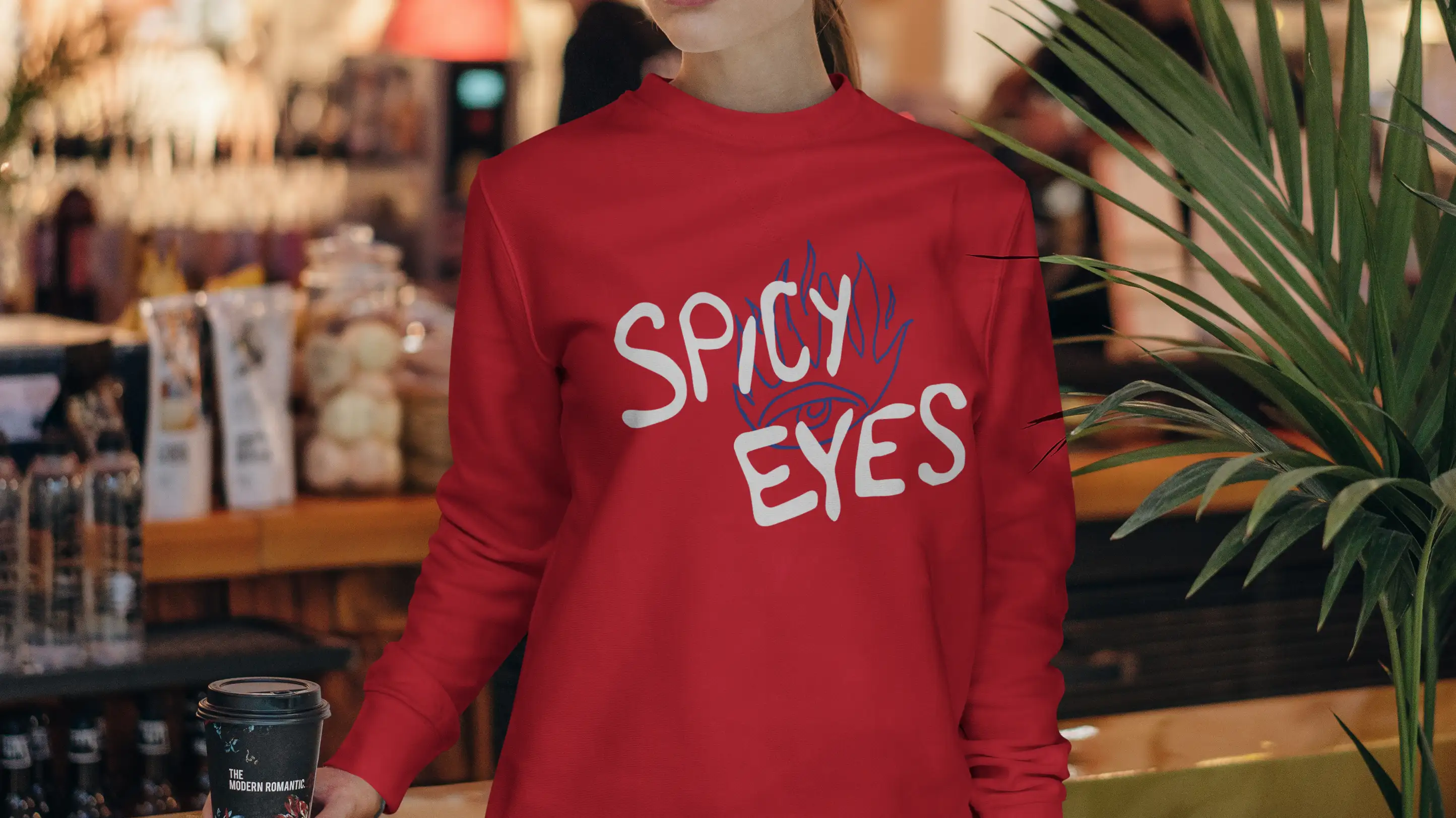 Spicy Eyes logo design on red sweatshirt.