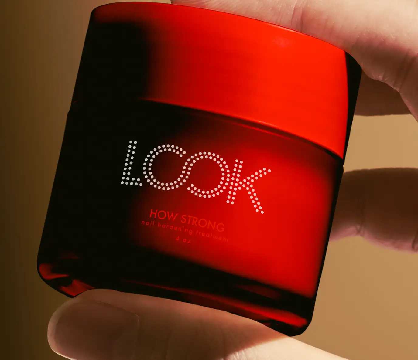 Close-up detail of Look brand packaging concept. Red jar with white logo.