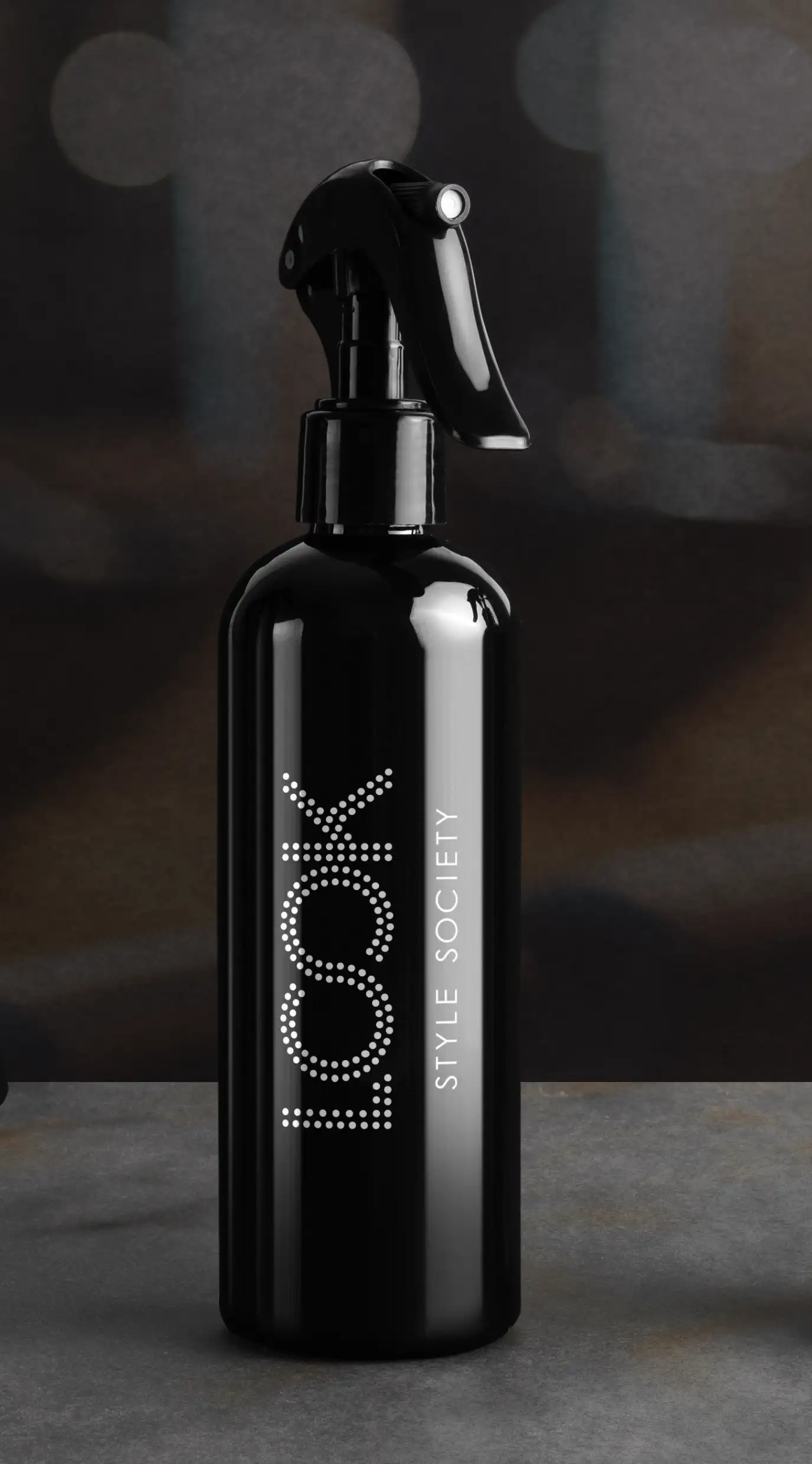 Look Style Society logo on dark black salon spray bottle.